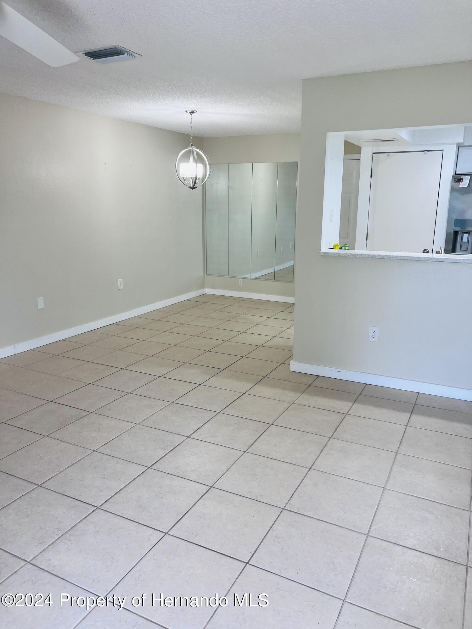 8141 Bugle Court Port Richey, FL 34668 - Photo 5 of 25 a view of an empty room and wooden shelves