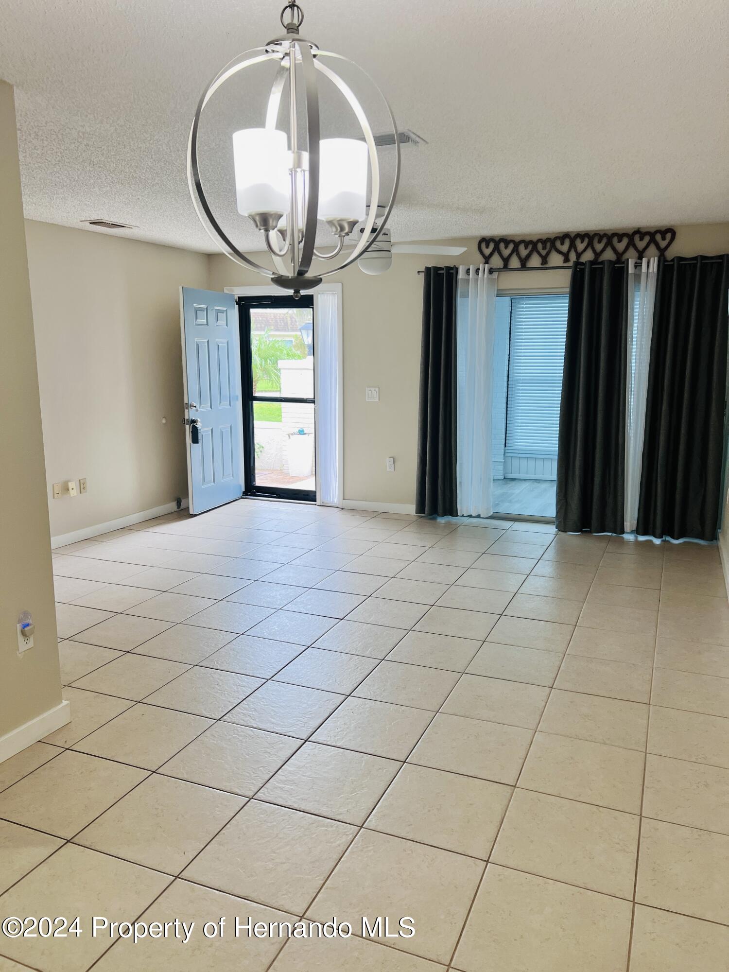 8141 Bugle Court Port Richey, FL 34668 - Photo 7 of 25 a view of a room with wooden floor and windows