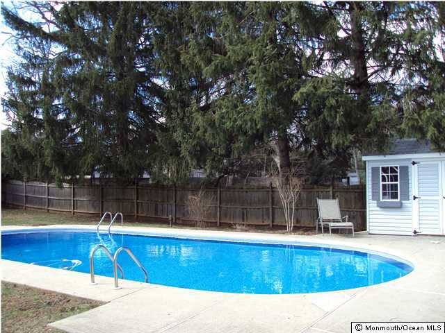 115 Jumping Brook Road Lincroft, NJ 07738 - Photo 2 of 3 a view of swimming pool with a patio