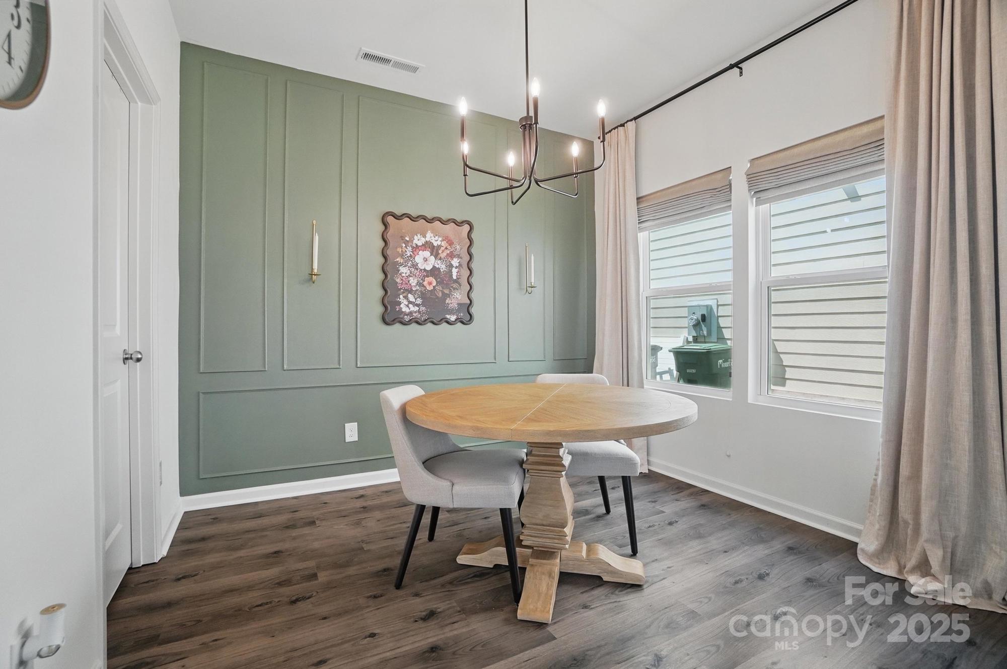637 Scotch Meadows Loop Monroe, NC 28110 - Photo 11 of 30 a view of a dining room with furniture window and wooden floor