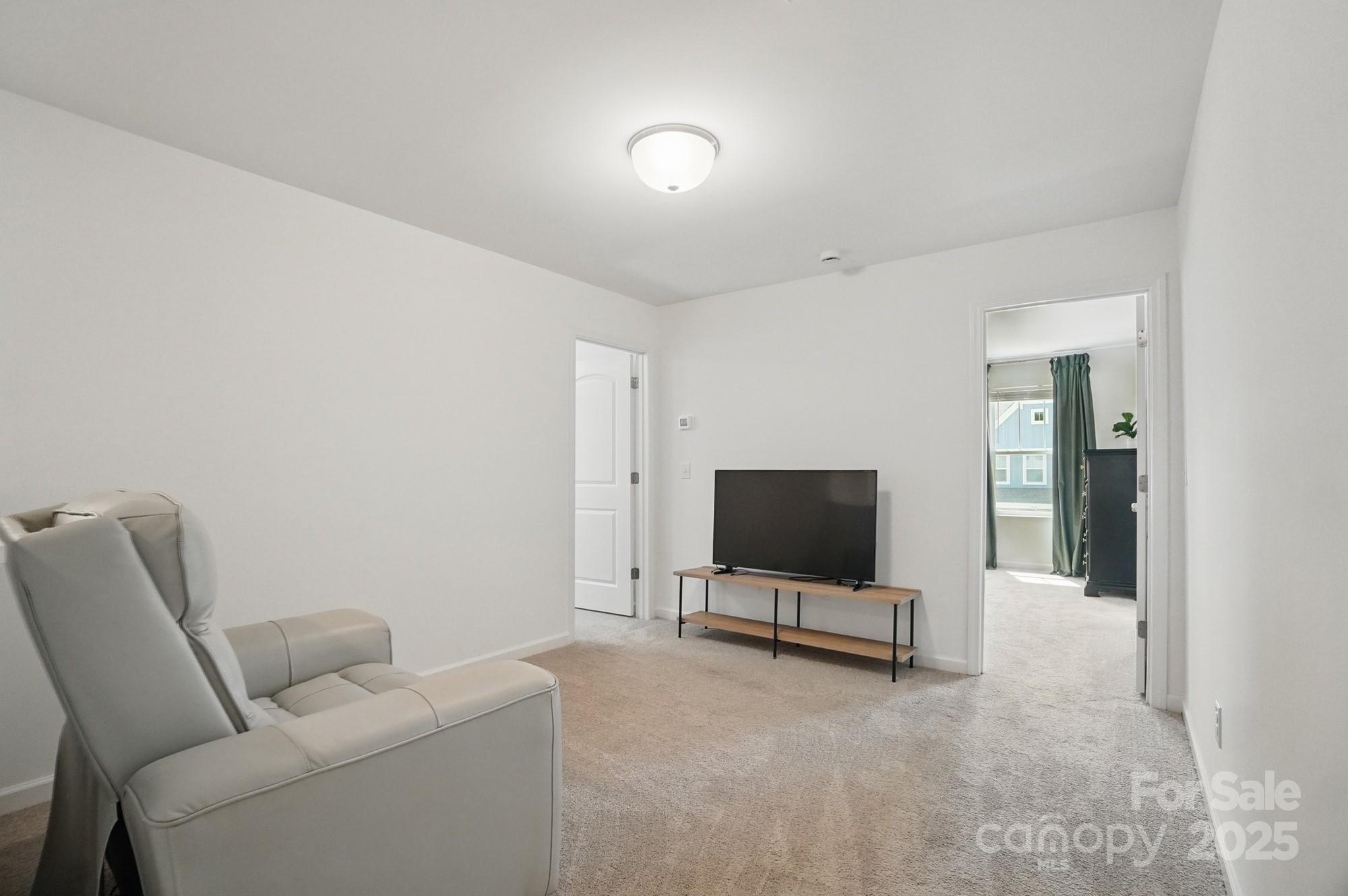 637 Scotch Meadows Loop Monroe, NC 28110 - Photo 16 of 30 a living room with furniture and a flat screen tv