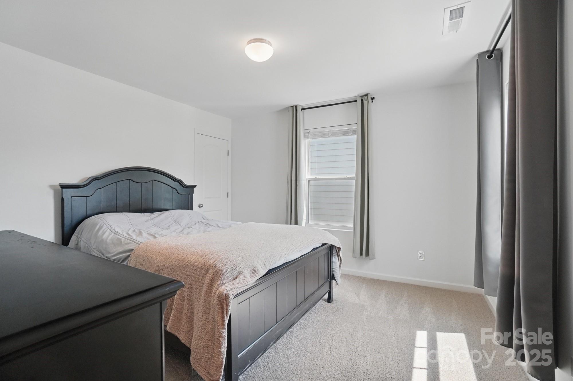 637 Scotch Meadows Loop Monroe, NC 28110 - Photo 20 of 30 a bedroom with a bed and a window