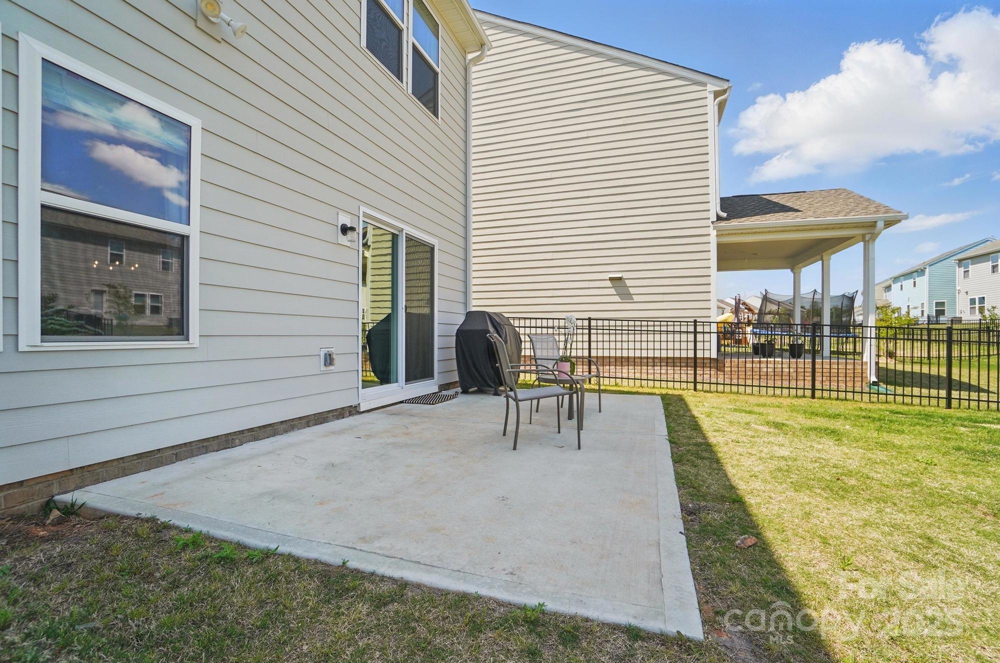637 Scotch Meadows Loop Monroe, NC 28110 - Photo 24 of 30 a view of a patio with a table and chairs