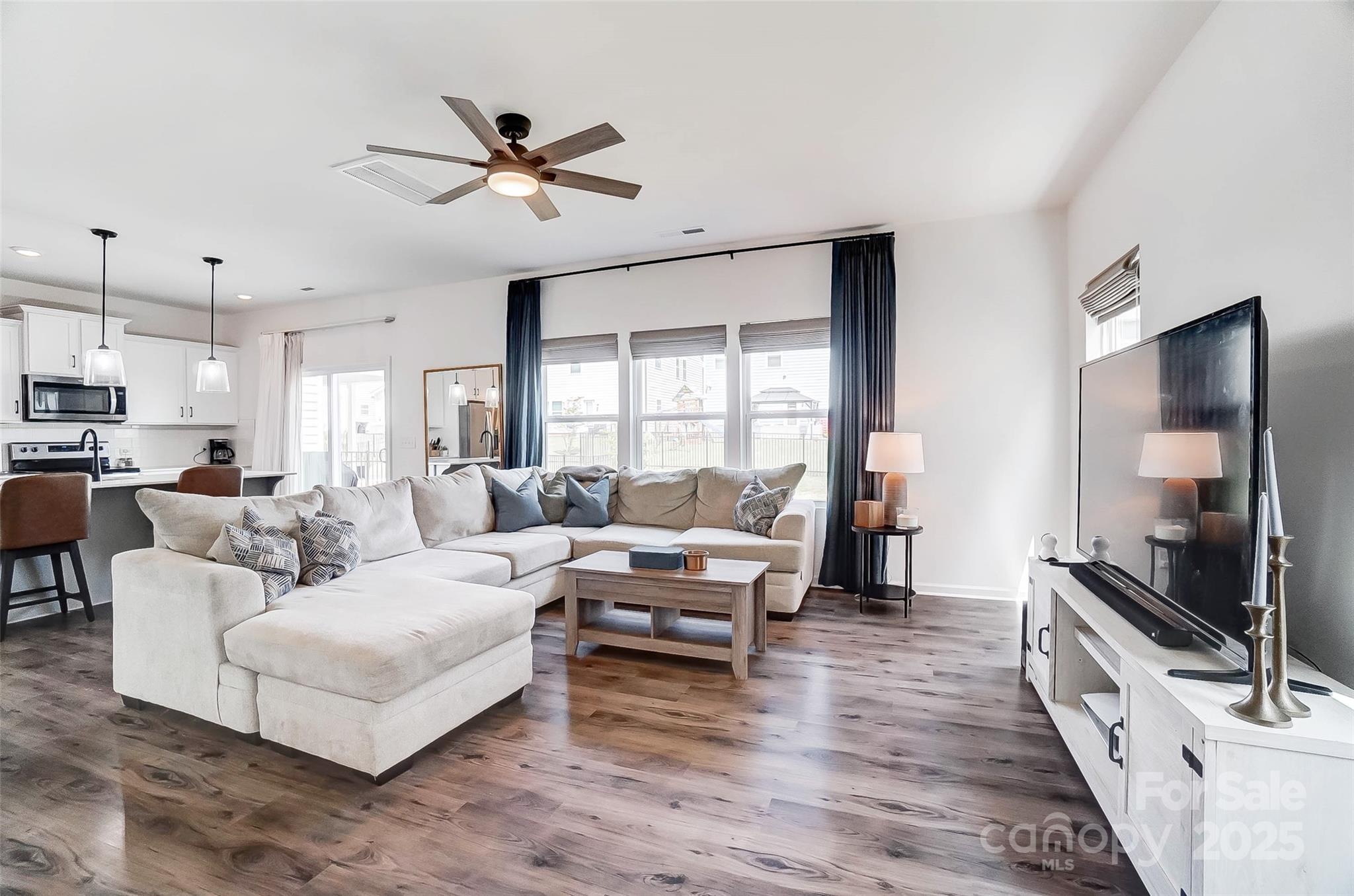 637 Scotch Meadows Loop Monroe, NC 28110 - Photo 5 of 30 a living room with furniture and a flat screen tv