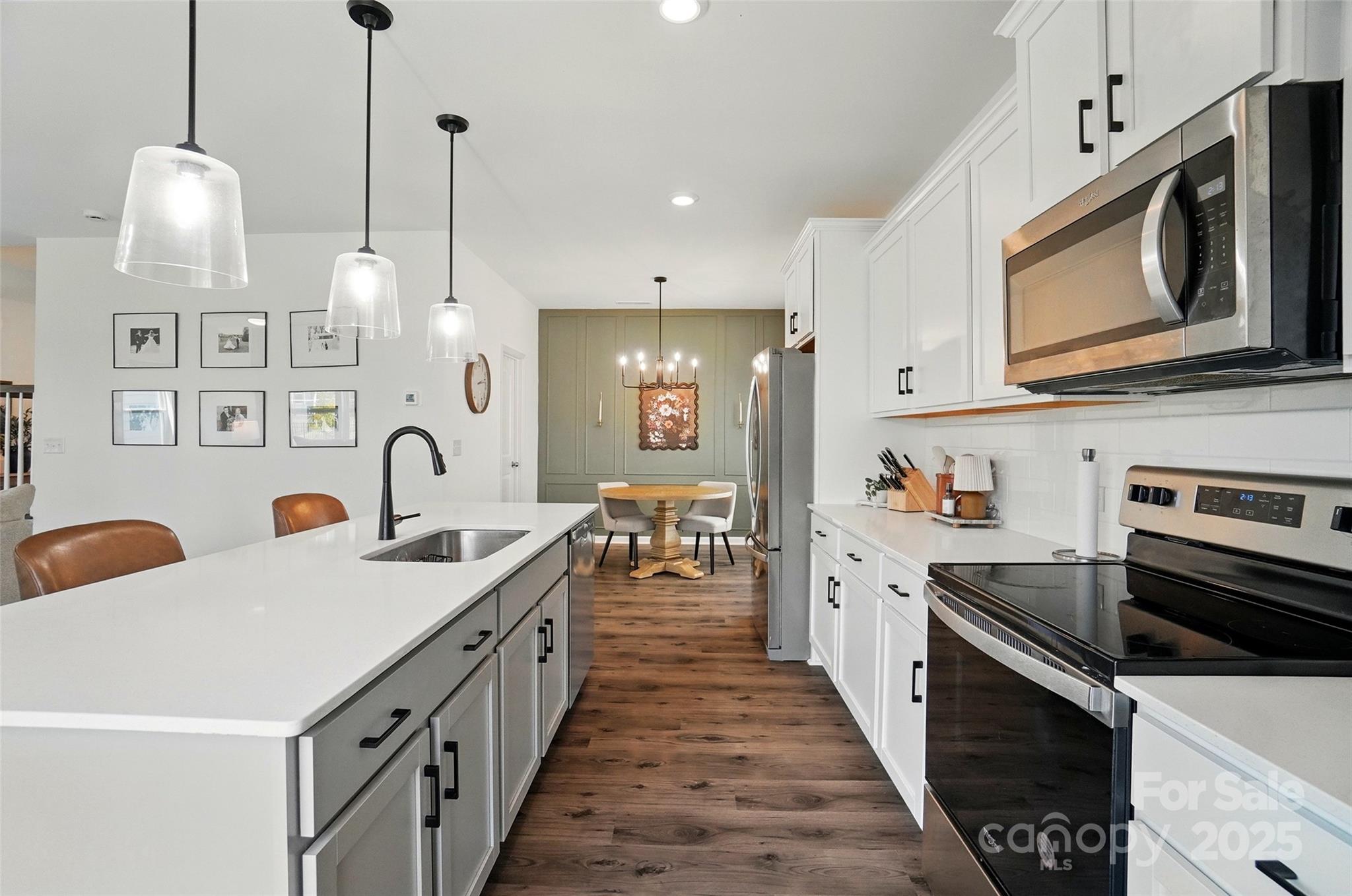 637 Scotch Meadows Loop Monroe, NC 28110 - Photo 9 of 30 a kitchen with stainless steel appliances a stove sink and cabinets