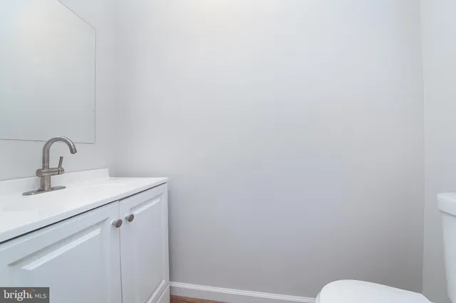 a bathroom with a sink mirror and toilet