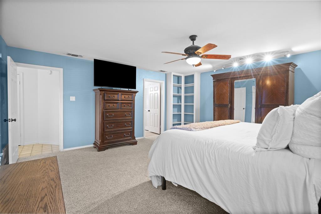 404 Laurel Trail North Terrell, TX 75160 - Photo 11 of 39 a bedroom with a bed and a flat screen tv