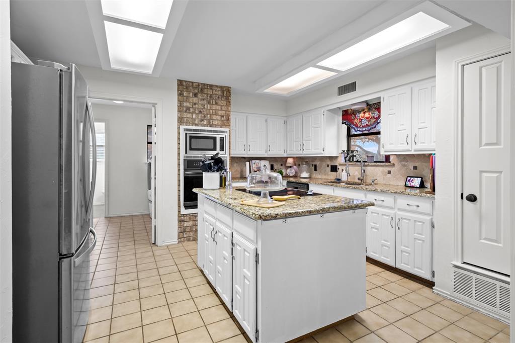 404 Laurel Trail North Terrell, TX 75160 - Photo 17 of 39 a kitchen with a sink stove and cabinets
