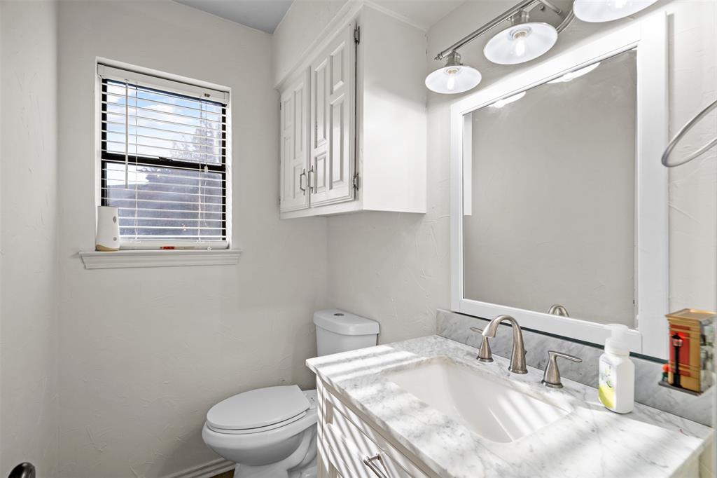 404 Laurel Trail North Terrell, TX 75160 - Photo 23 of 39 a bathroom with a sink a toilet and a window
