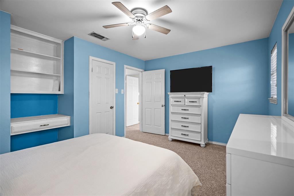 404 Laurel Trail North Terrell, TX 75160 - Photo 31 of 39 a bedroom with a bed and a flat screen tv