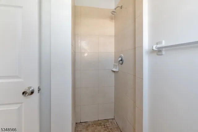 a bathroom with a glass shower door