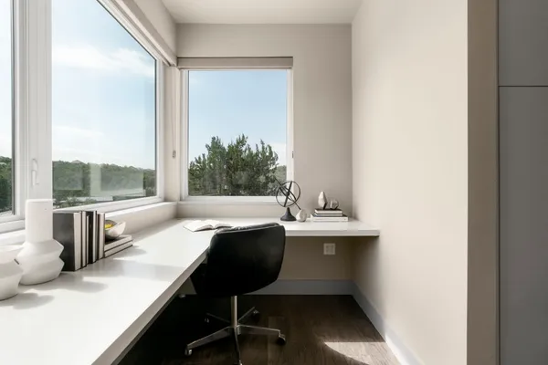 an empty room with furniture and windows
