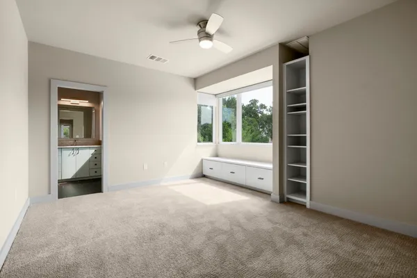 a view of a bathroom with mirror and window