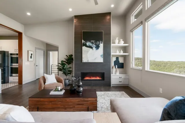 a living room with furniture and a view of kitchen
