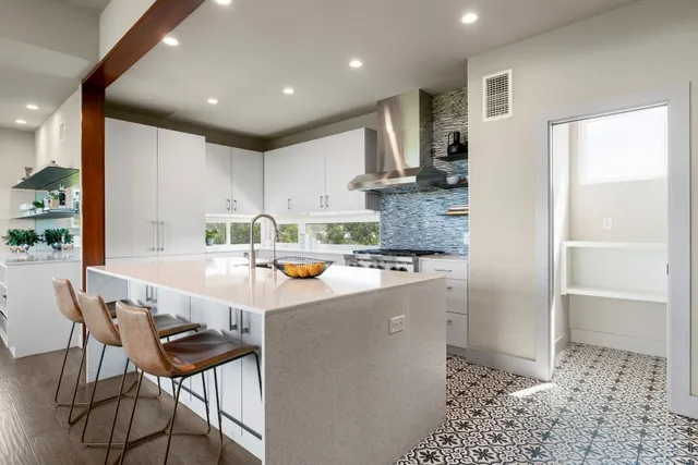 a kitchen with a sink appliances and cabinets