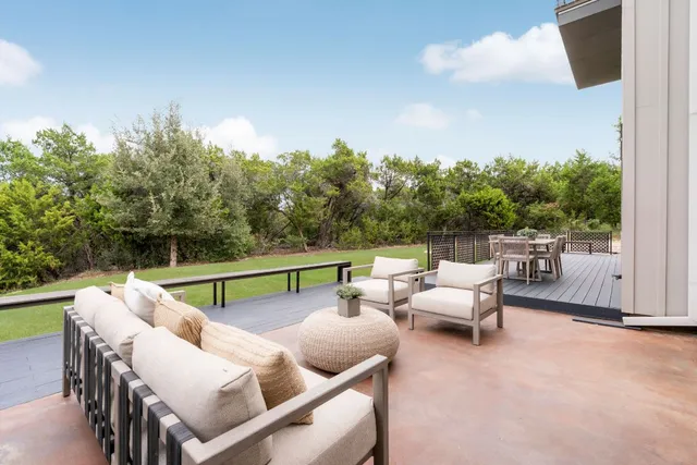 a view of a roof deck with table and chairs
