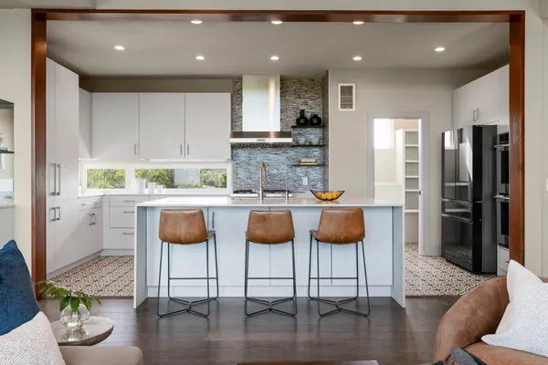 a kitchen with stainless steel appliances granite countertop a refrigerator and a stove top oven