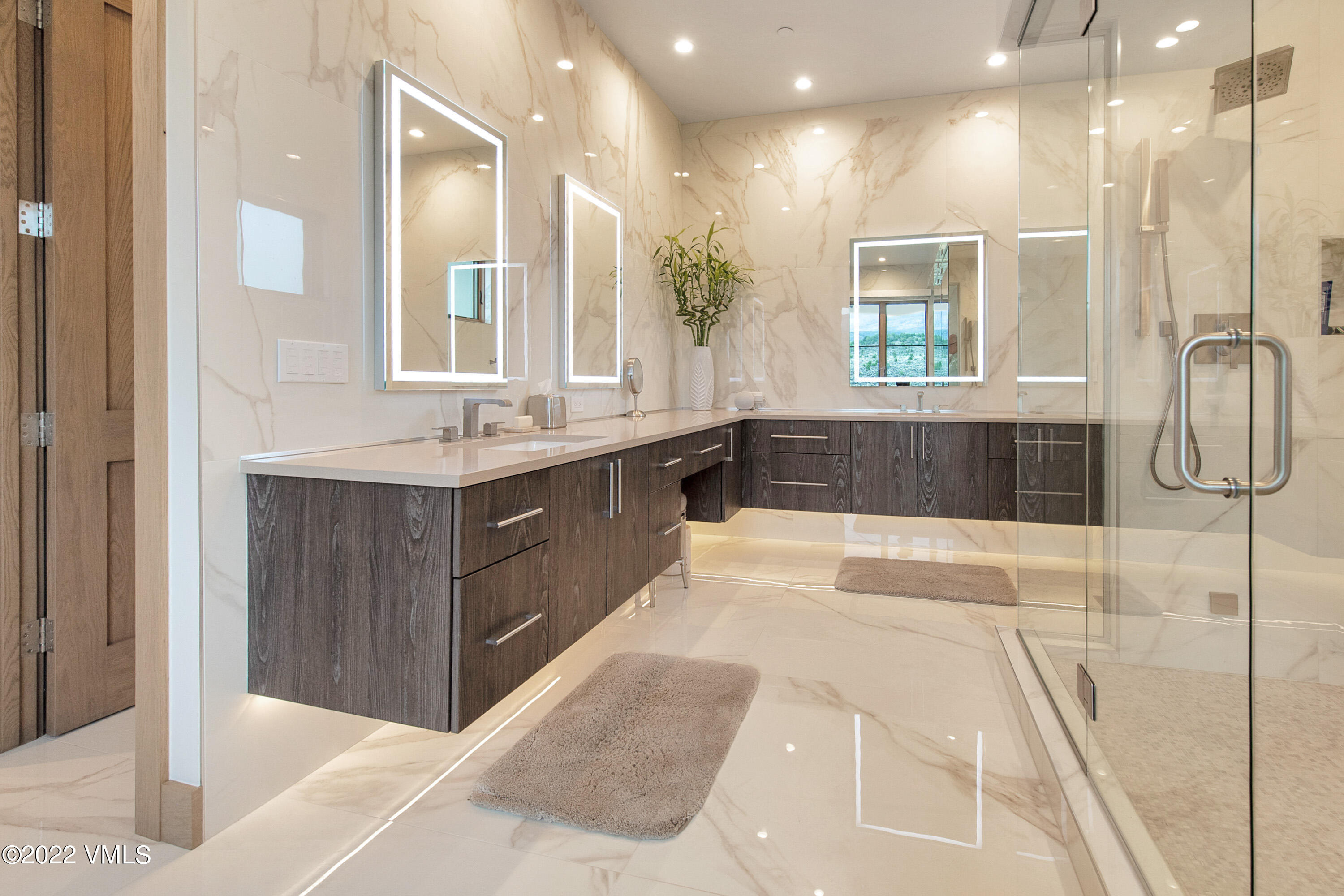 2185 East Haystacker Drive Eagle, CO 81631 - Photo 12 of 30 a large bathroom with a large tub shower sink and mirror