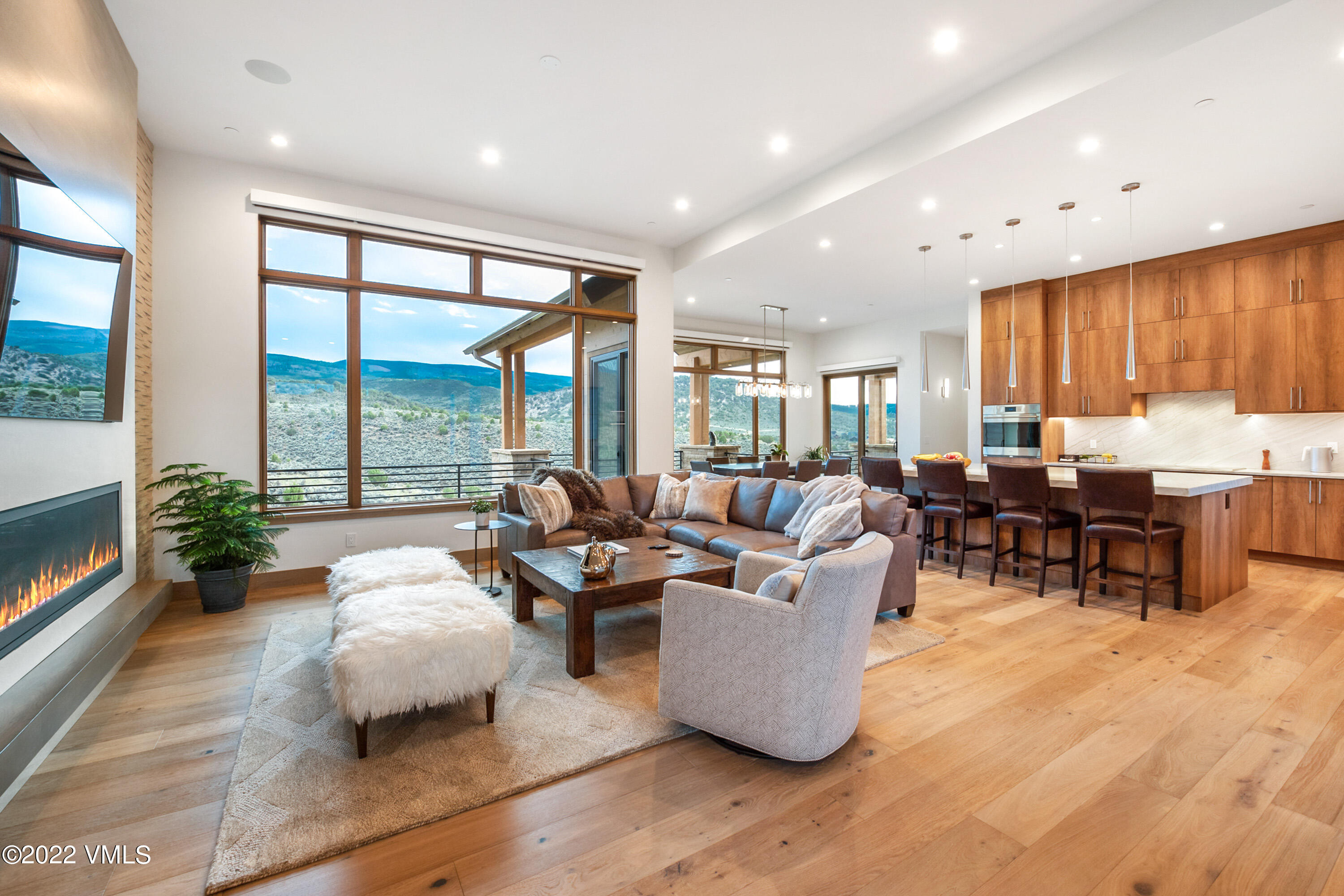 2185 East Haystacker Drive Eagle, CO 81631 - Photo 2 of 30 a living room with fireplace furniture and floor to ceiling windows
