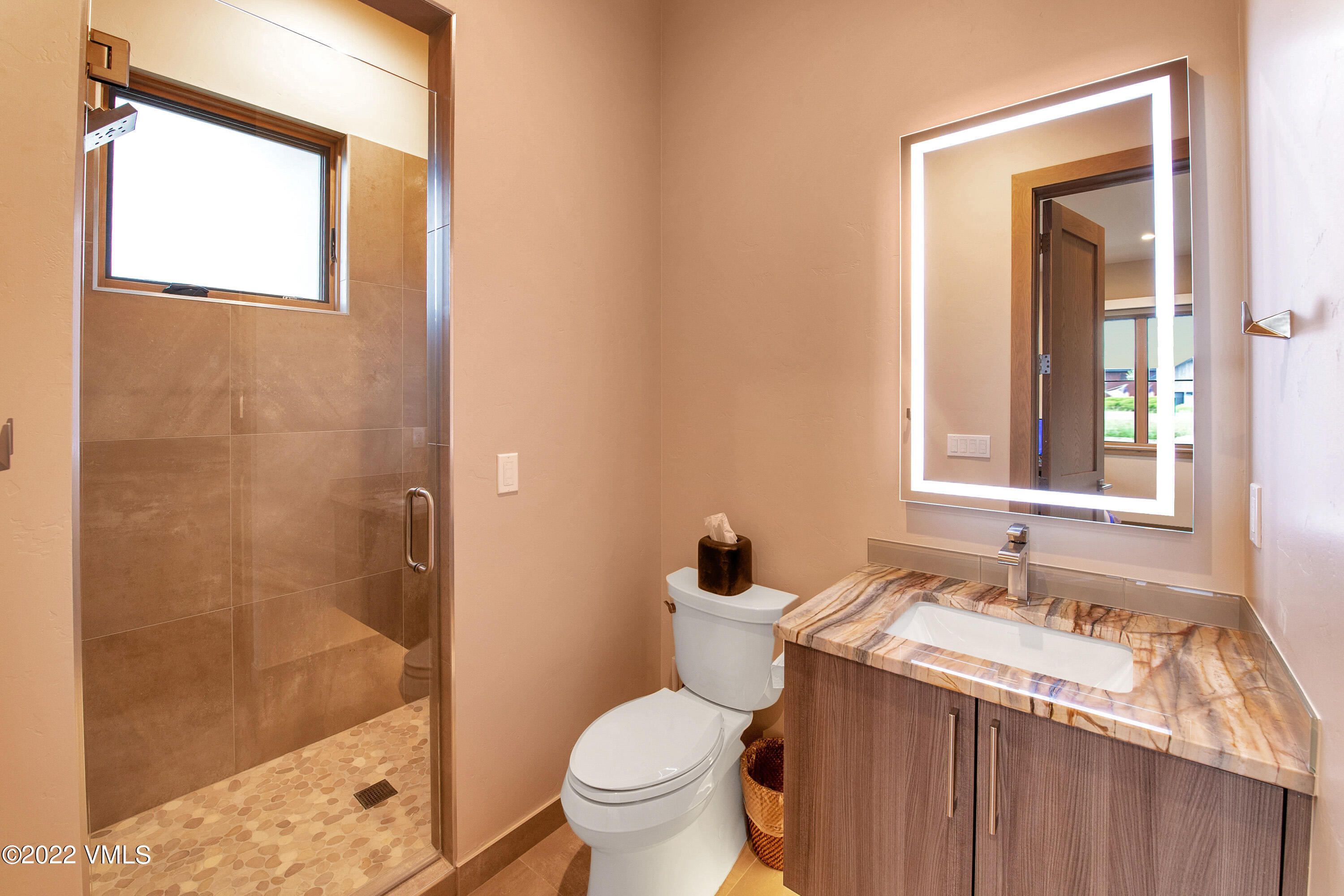 2185 East Haystacker Drive Eagle, CO 81631 - Photo 22 of 30 a bathroom with a granite countertop sink toilet and shower