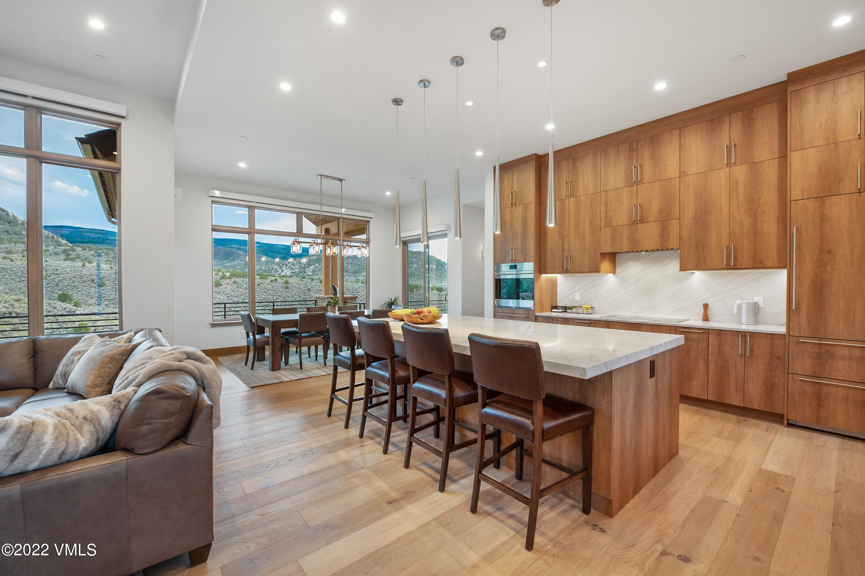 2185 East Haystacker Drive Eagle, CO 81631 - Photo 3 of 30 a dining hall with stainless steel appliances granite countertop a living room kitchen island furniture and a large window