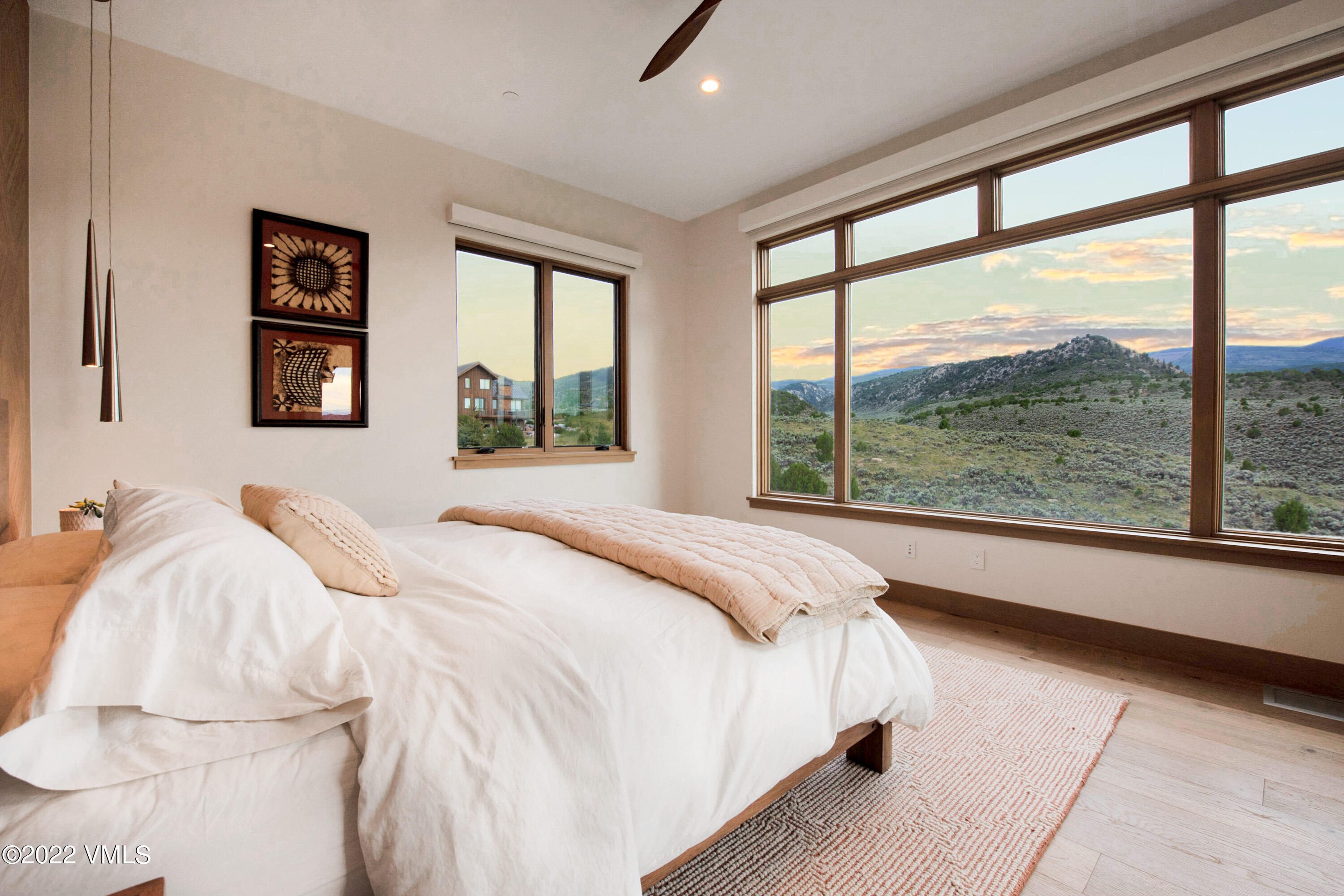 2185 East Haystacker Drive Eagle, CO 81631 - Photo 10 of 30 a bedroom with a large window and a bed