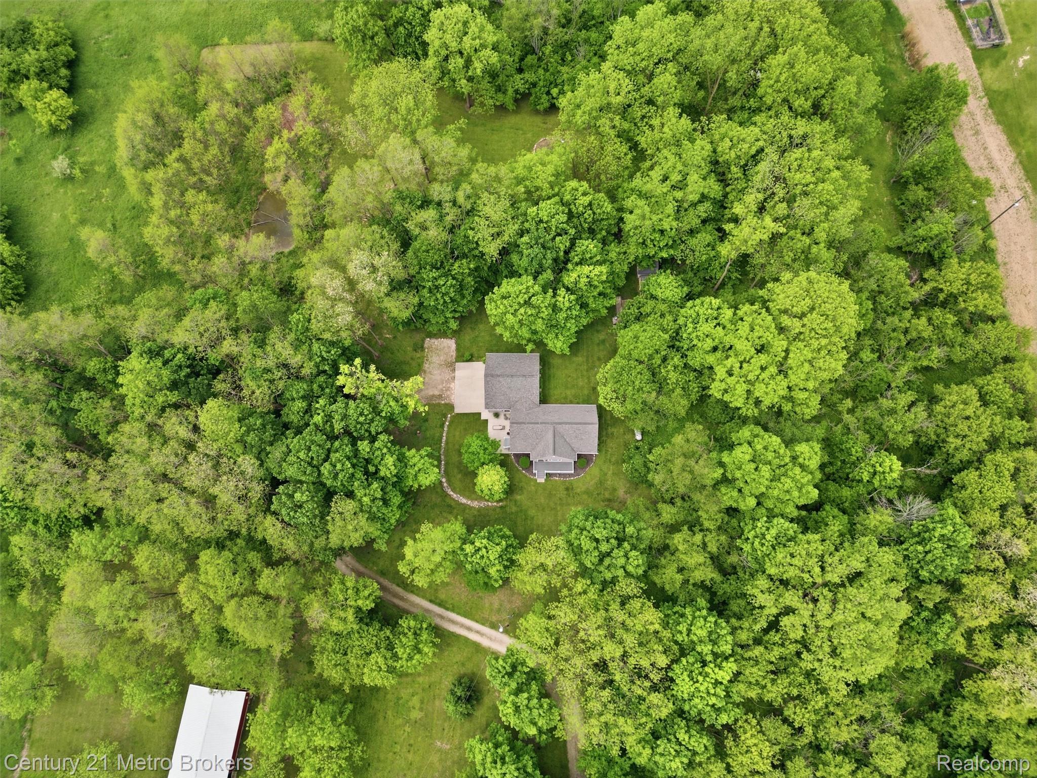 11447 North Latson Road Linden, MI 48451 - Photo 49 of 52 Aerial perspective showcasing a single-family residence surrounded by mature trees