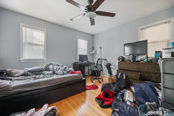a living room with furniture and a wooden floor