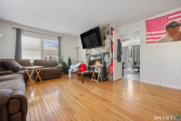 a living room with furniture a wooden floor and a window