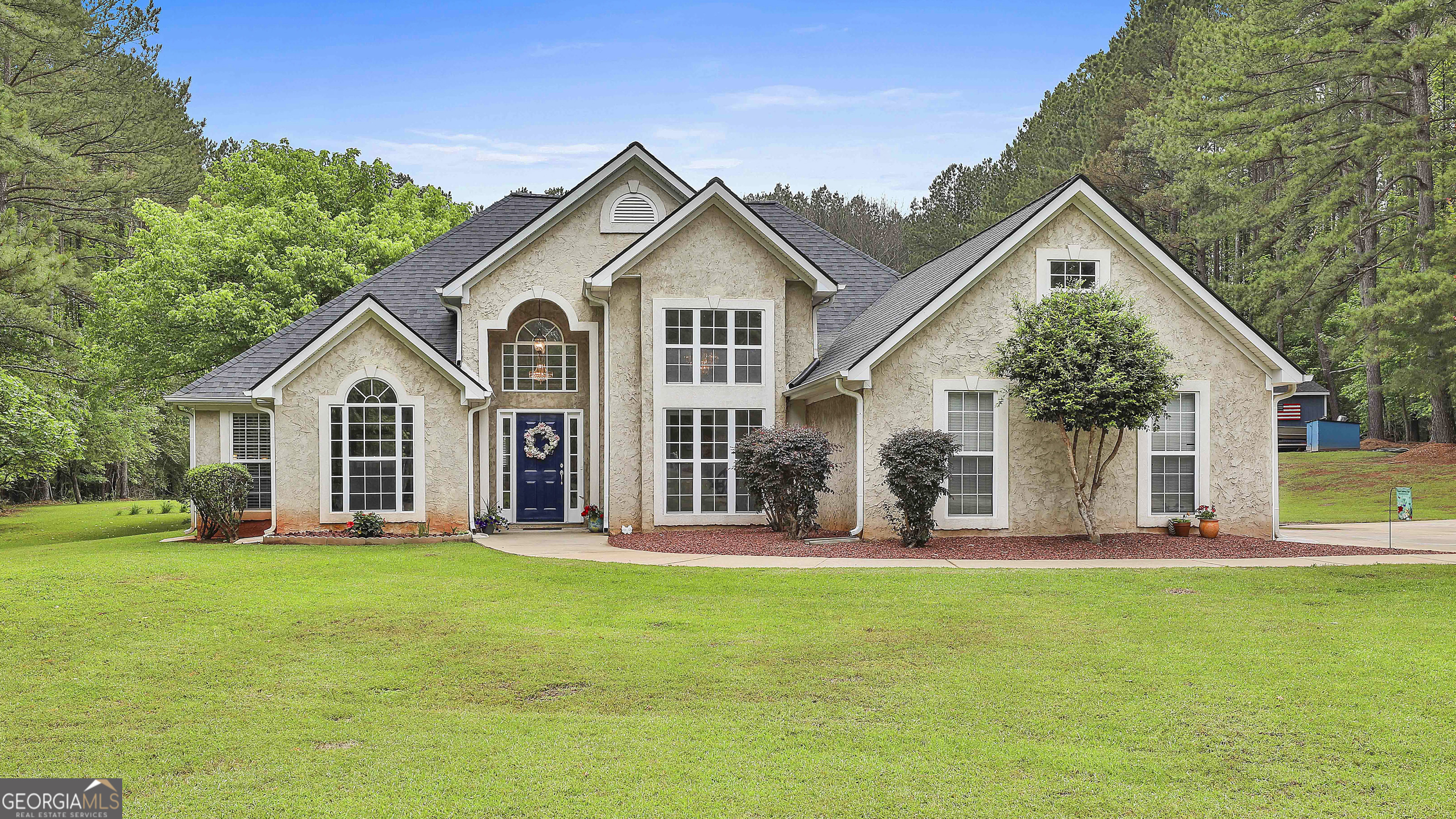 a front view of house with yard and green space
