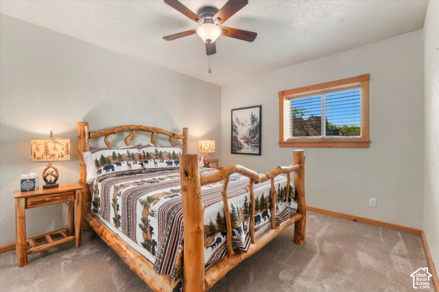 1701 Oak Road Coalville, UT 84017 - Photo 36 of 71 Carpeted flooring, a window with wood trim, and a ceiling fan with integrated lighting