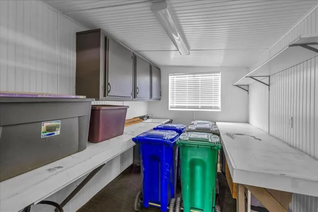 a view of a patio with a table and chairs under an umbrella