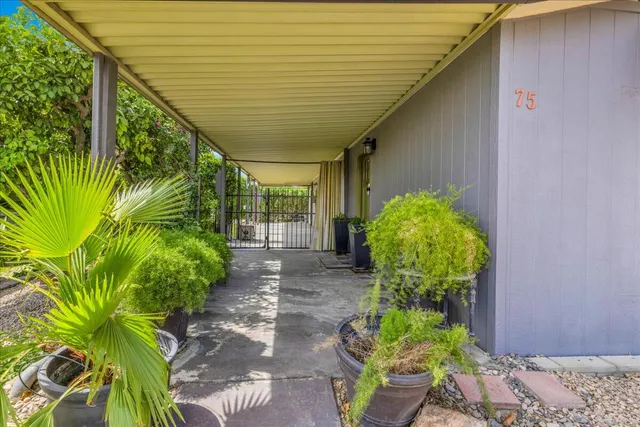 a view of a house with swimming pool and sitting area