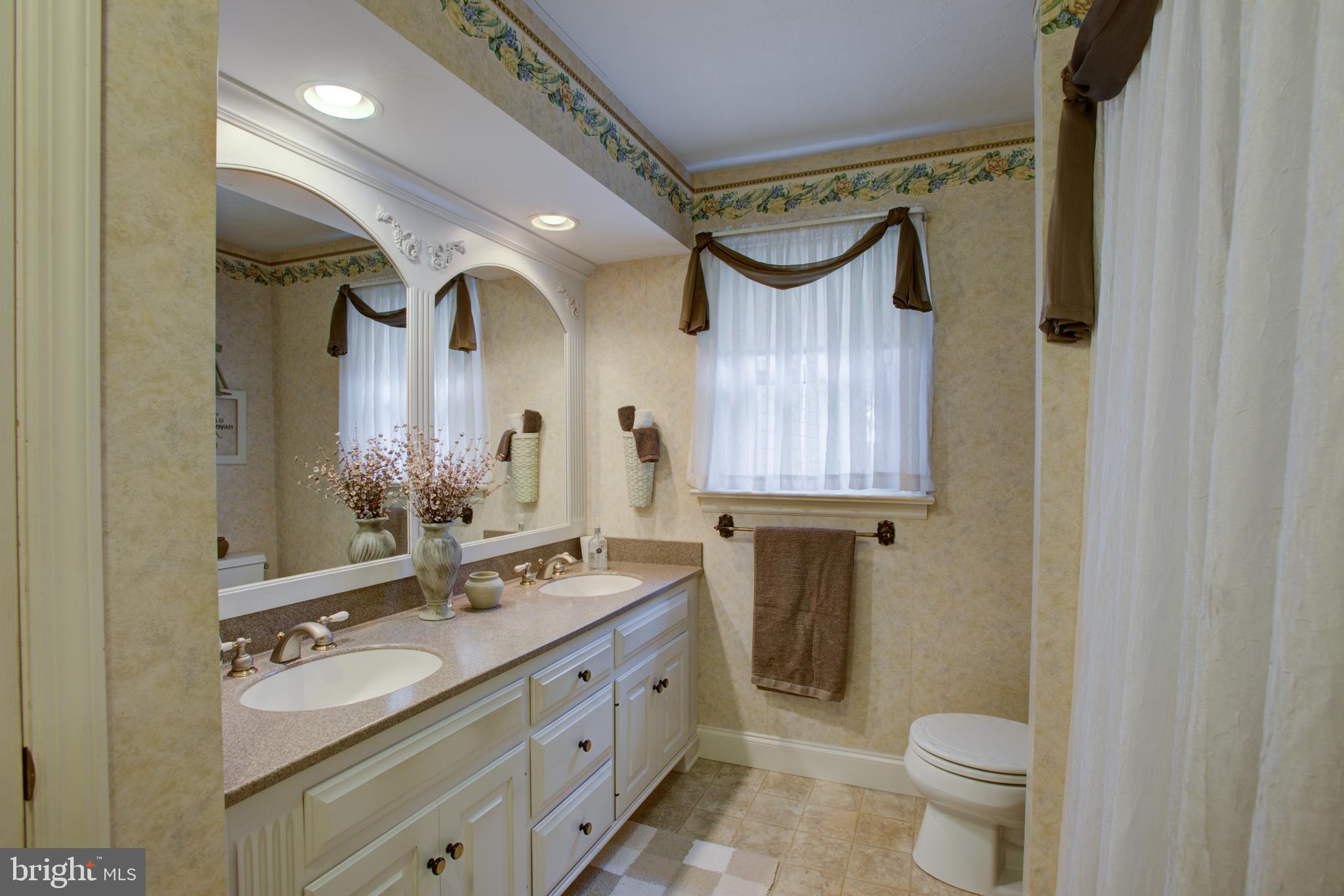 116 Meetinghouse Road Gap, PA 17527 - Photo 48 of 66 a bathroom with a double vanity sink toilet mirror and shower