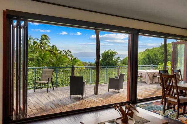 a room with pool table and chairs