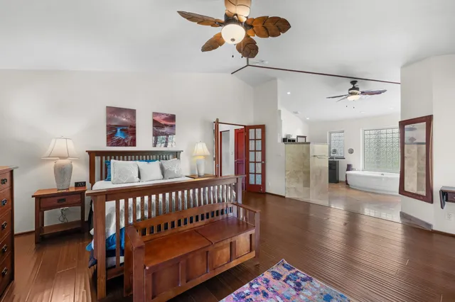 a bedroom with furniture and wooden floor