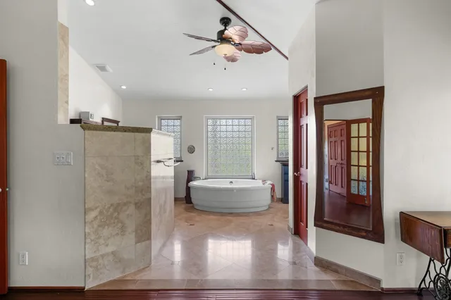 a living room with stainless steel appliances kitchen island granite countertop a refrigerator and cabinets
