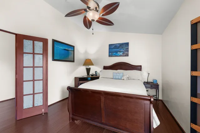 a bedroom with a bed and a flat screen tv