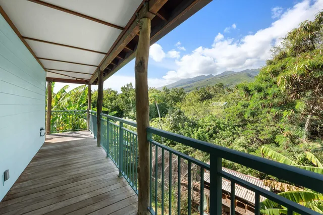 a view of balcony with wooden floor and lake view