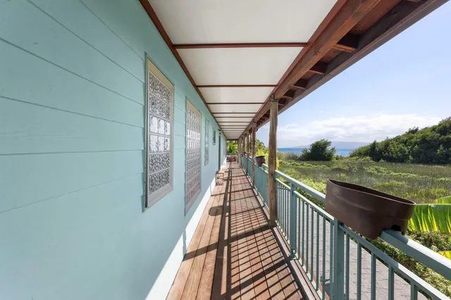 a view of a balcony with wooden floor and outdoor seating