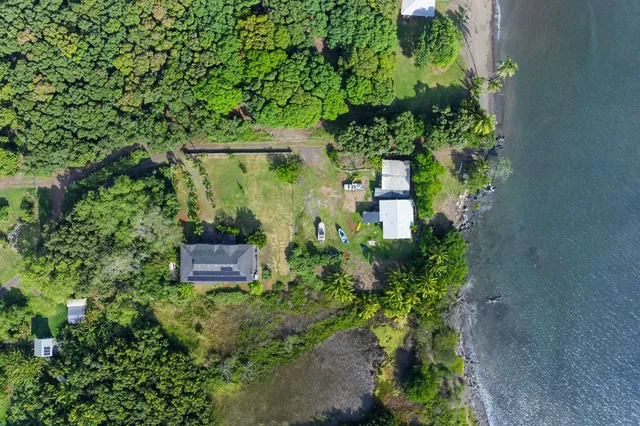 an aerial view of a house with a yard