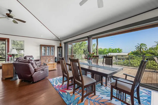 a dining room with furniture and a floor to ceiling window