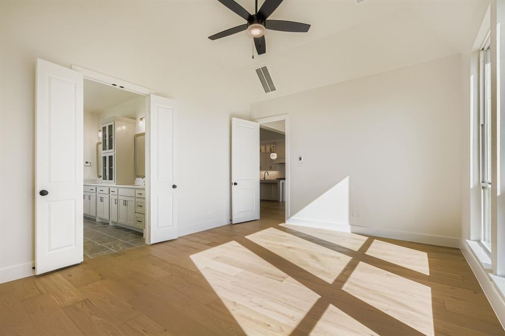 2651 Merrell Court Prosper, TX 75078 - Photo 14 of 28 a bedroom with a bed and a large window
