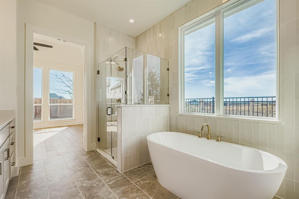 2651 Merrell Court Prosper, TX 75078 - Photo 16 of 28 a bathroom with a bathtub and a shower