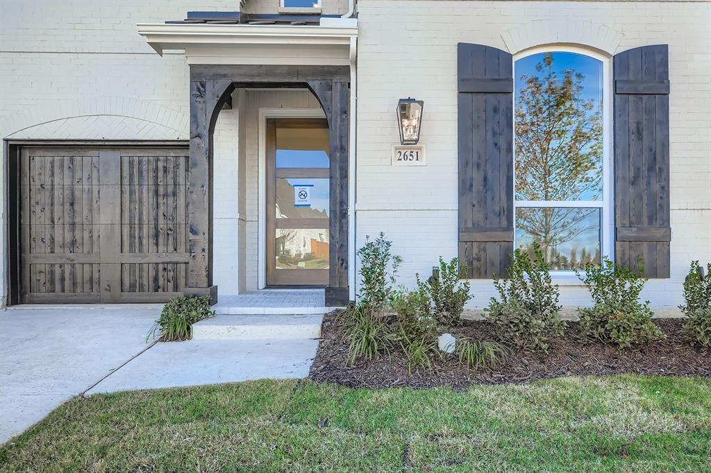 2651 Merrell Court Prosper, TX 75078 - Photo 3 of 28 a front view of a house with garden