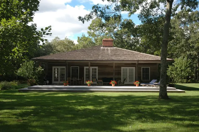 a front view of house with outdoor seating and yard