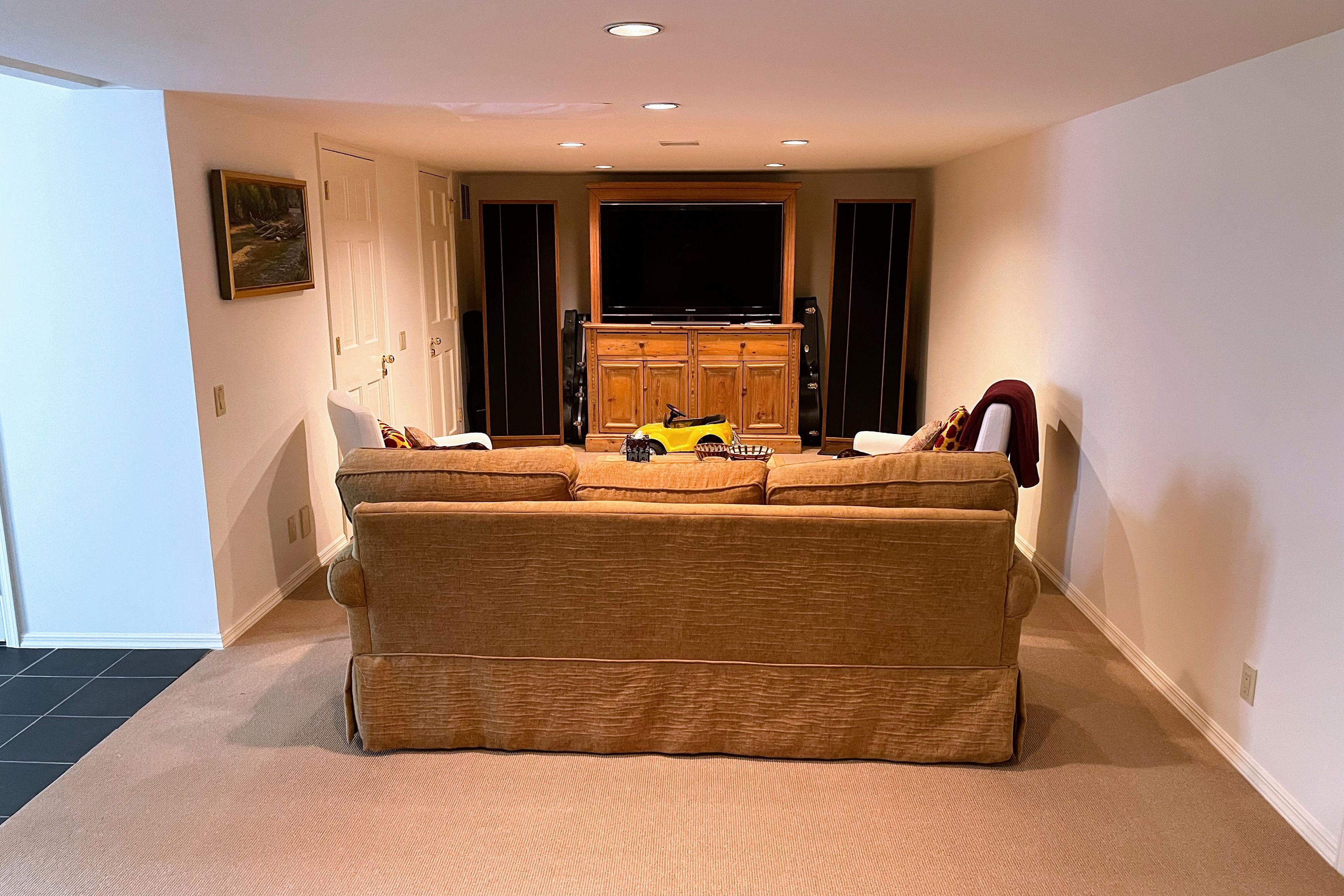 Undisclosed Address East Hampton, NY 11937 - Photo 12 of 14 a room with a couch and a flat screen tv
