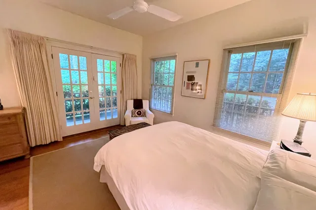 a bedroom with a bed and a large window
