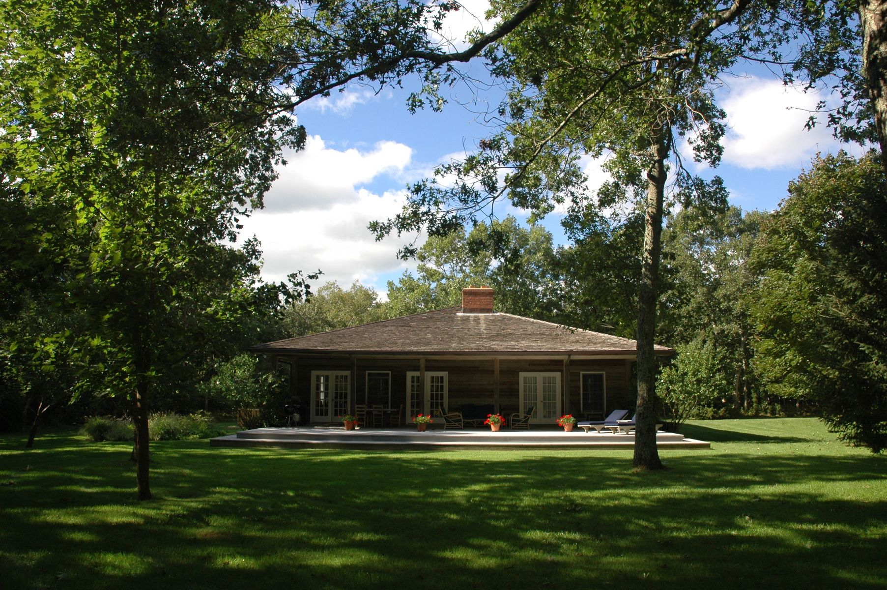 Undisclosed Address East Hampton, NY 11937 - Photo 2 of 14 a front view of house with yard and green space