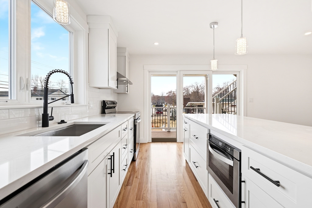 2 Old County Road, Unit 12 Salisbury, MA 01952 - Photo 7 of 29 a large kitchen with stainless steel appliances granite countertop a lot of counter space and wooden floor